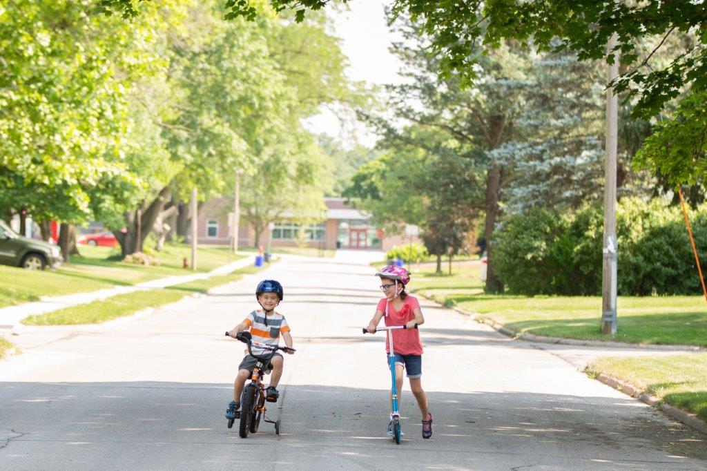 kids riding bike in street