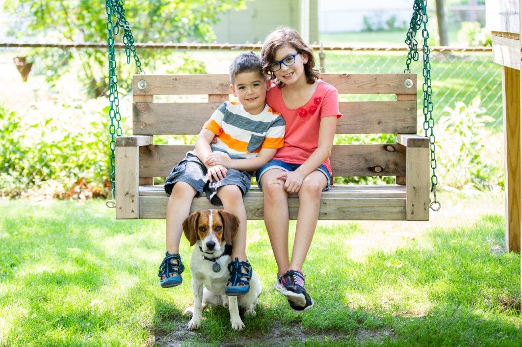 family on wooden swing