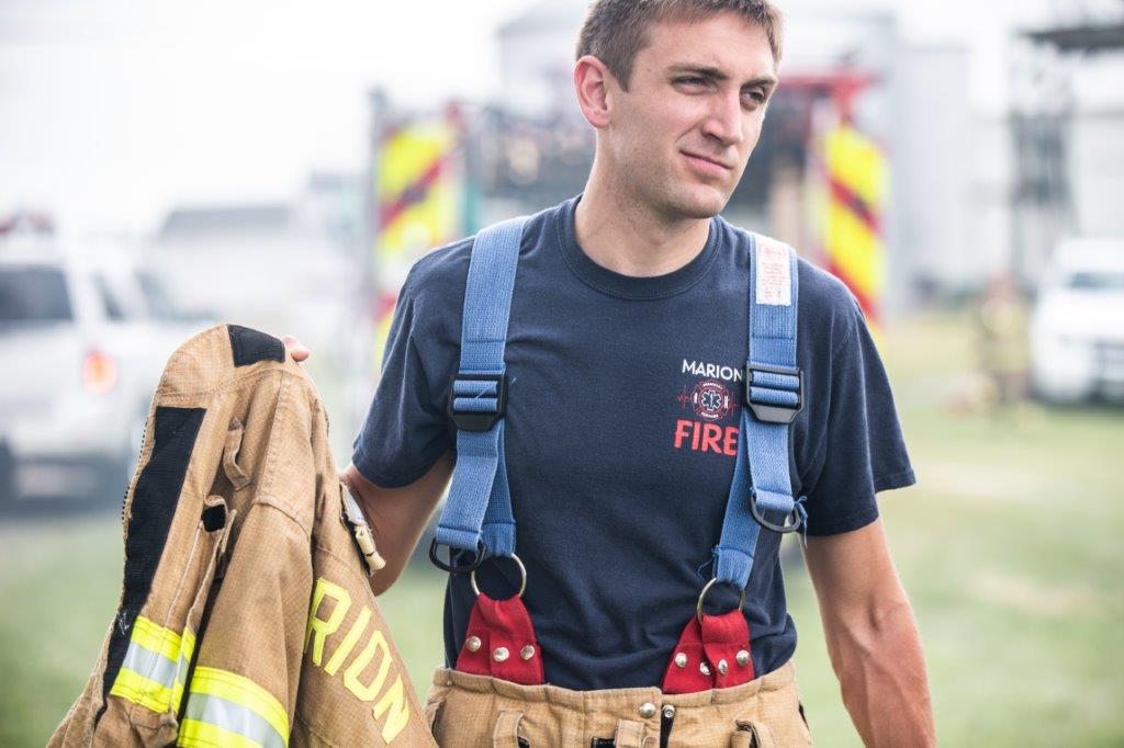 firefighter carrying coat