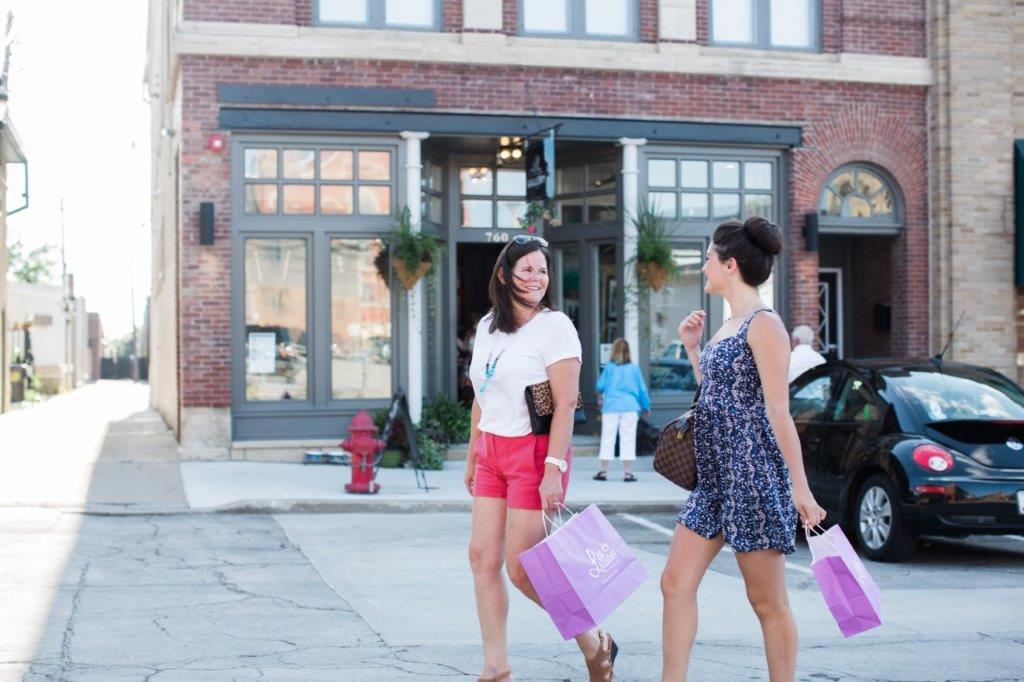 two ladies in front of stores