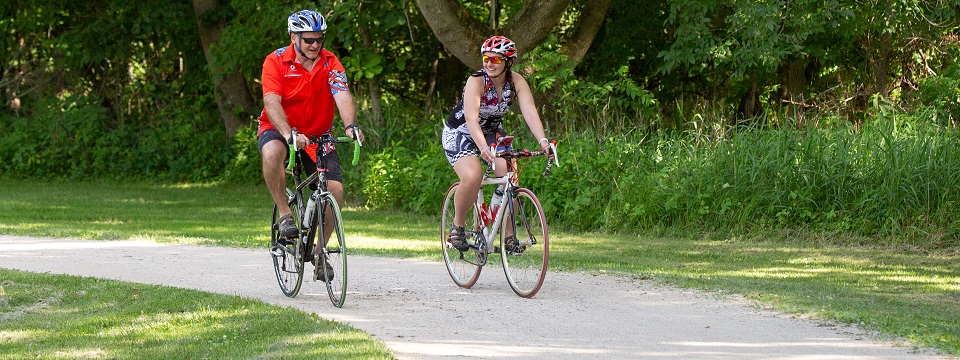 man and woman bicycling on trail