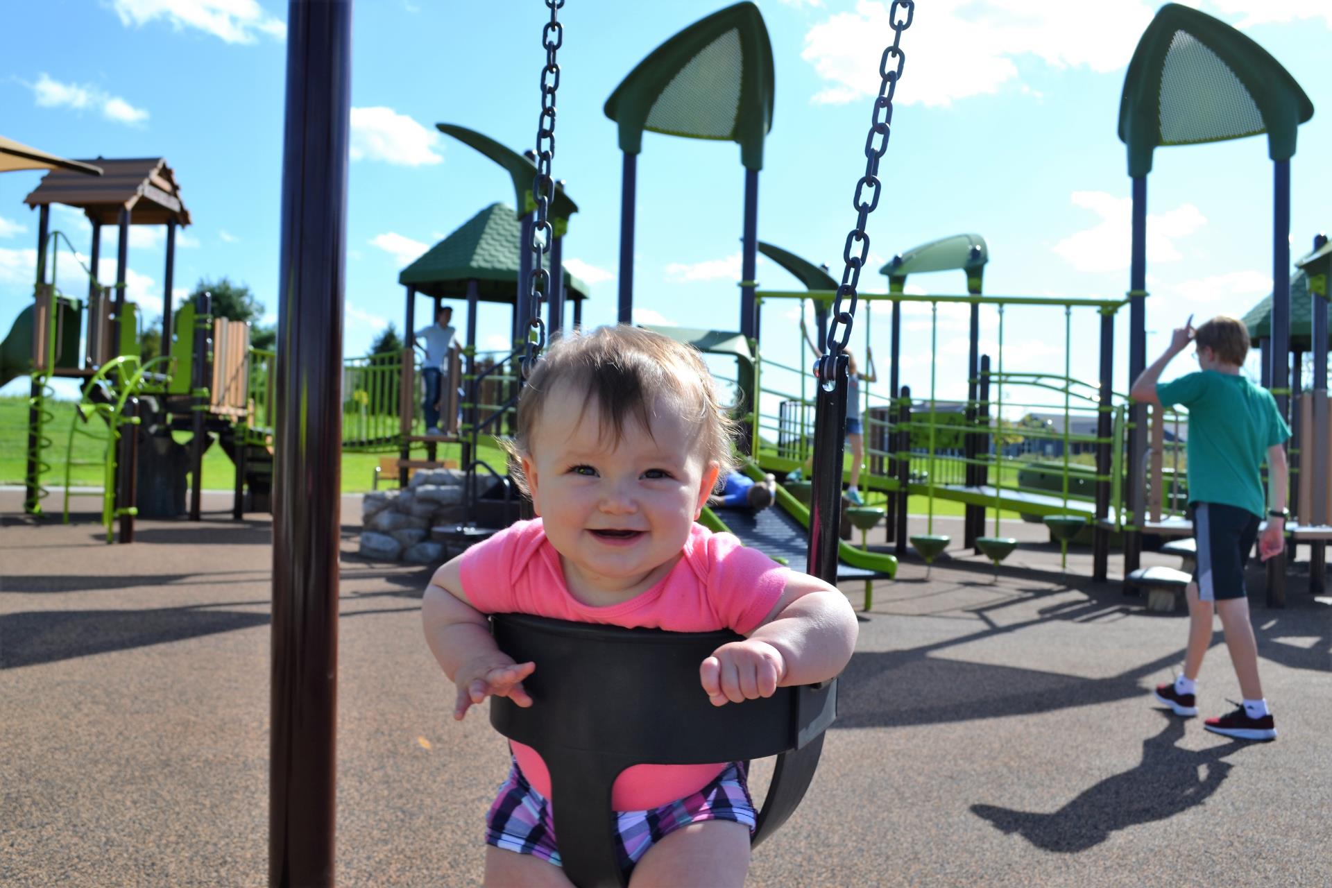 girl in swing on playground