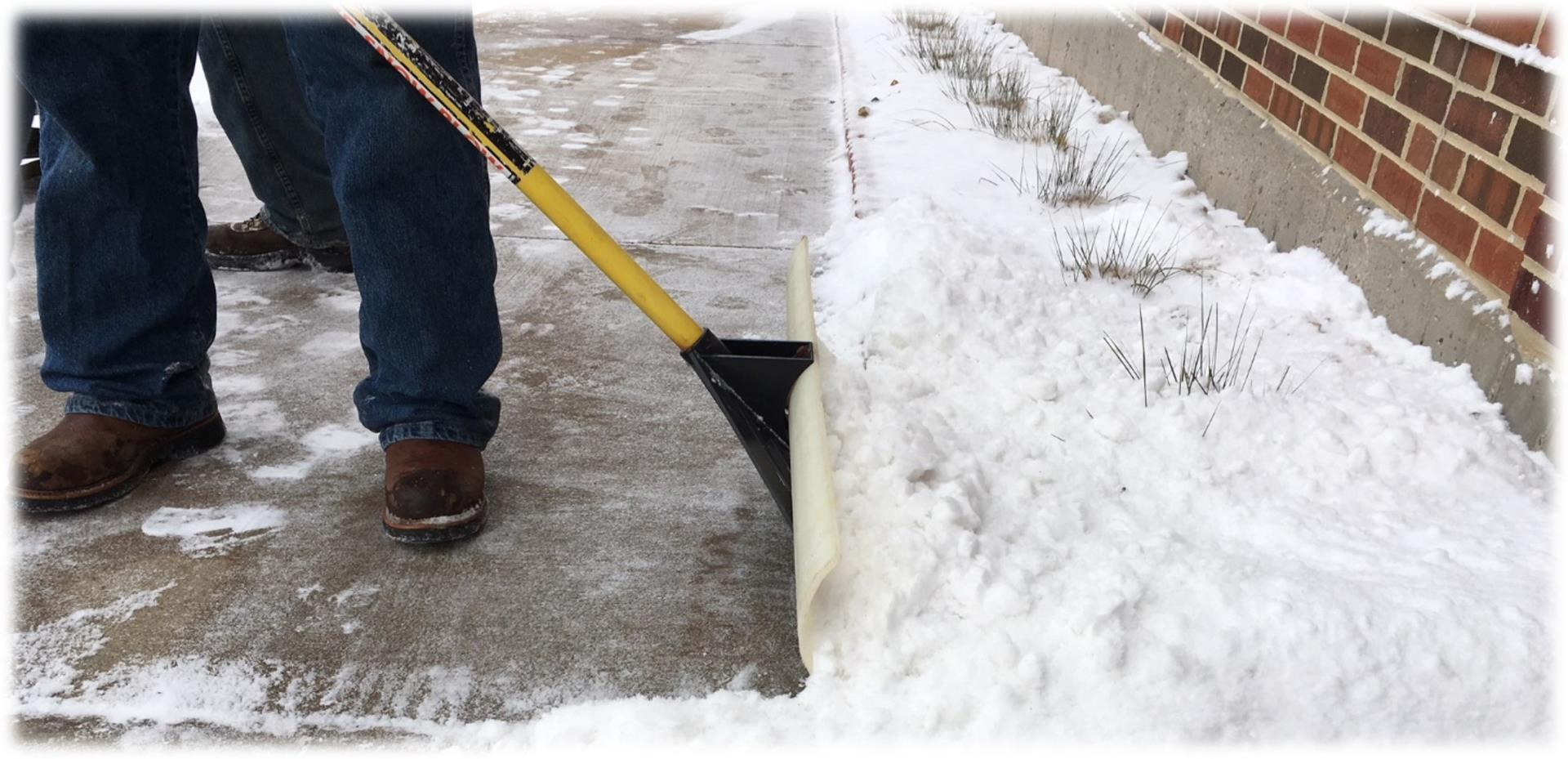 shoveling snow on sidewalk