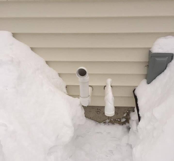 snow cleared around furnace pipes