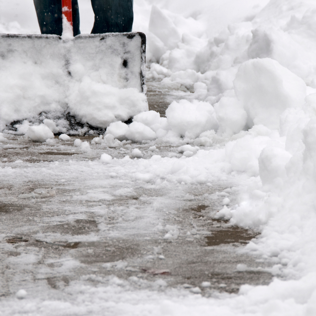 person shoveling sidewalk